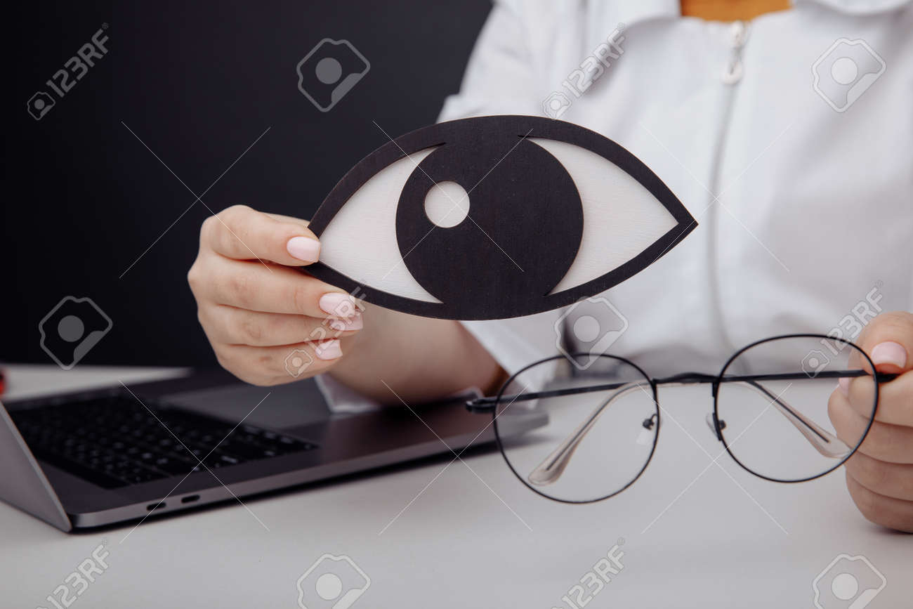 Wooden eye in doctors hand close-up - 169819667 Wooden eye in doctors hand close-up - 169819667