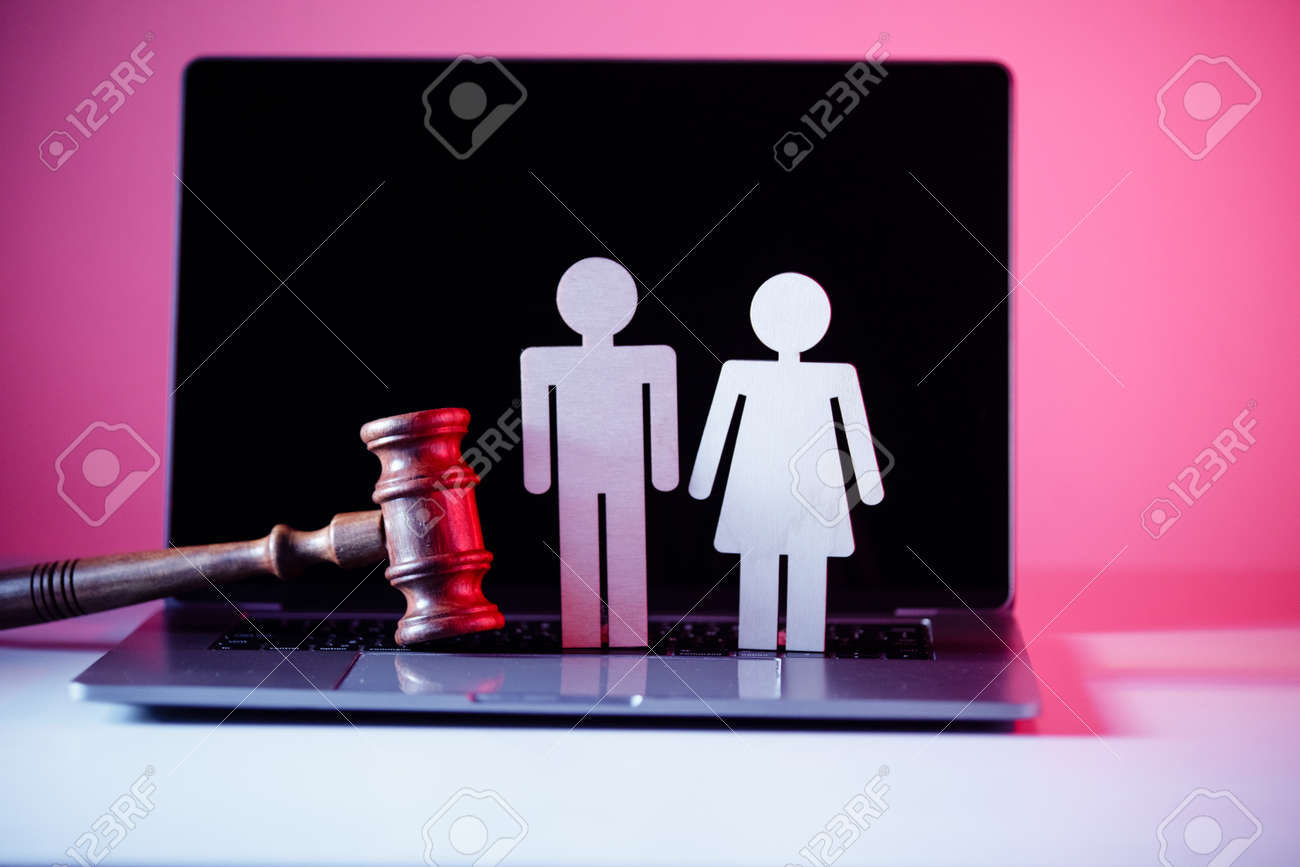 Wooden figure in shape of people and gavel on the table. Family law concept - 169820259 Wooden figure in shape of people and gavel on the table. Family law concept - 169820259
