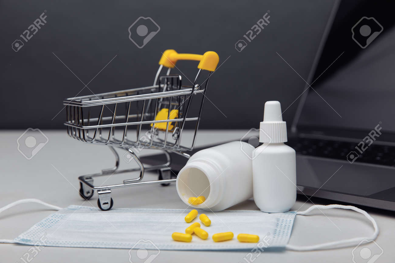 Small shopping cart with medicines. Concept for online purchase of medicines - 169820264 Small shopping cart with medicines. Concept for online purchase of medicines - 169820264