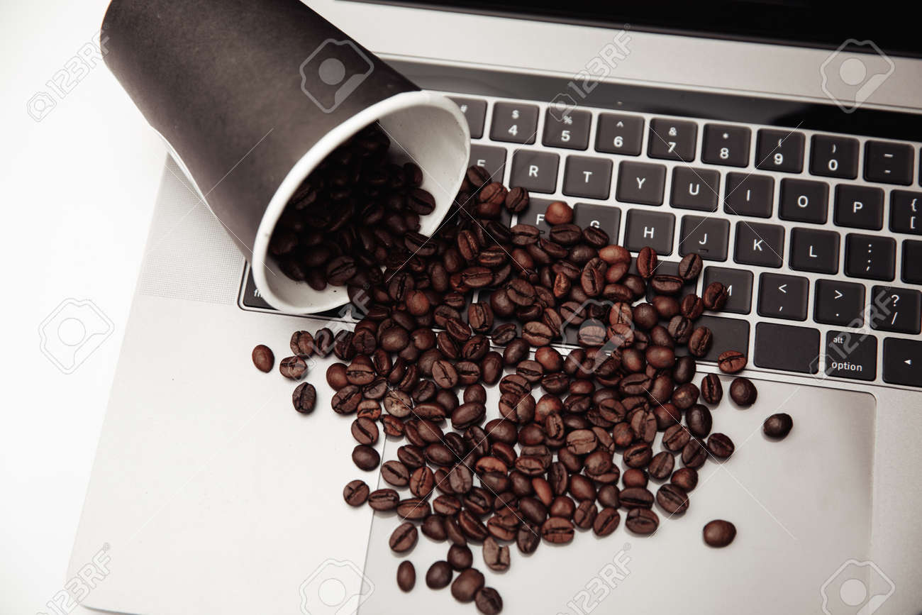 Paper cup and coffee beans on keyboard at the white desk - 169820851 Paper cup and coffee beans on keyboard at the white desk - 169820851