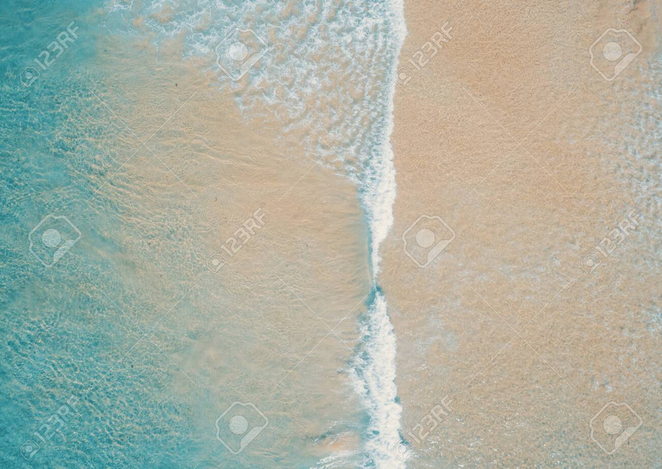 Aerial top view of turquoise ocean wave reaching the coastline. - 136691261 Aerial top view of turquoise ocean wave reaching the coastline. - 136691261