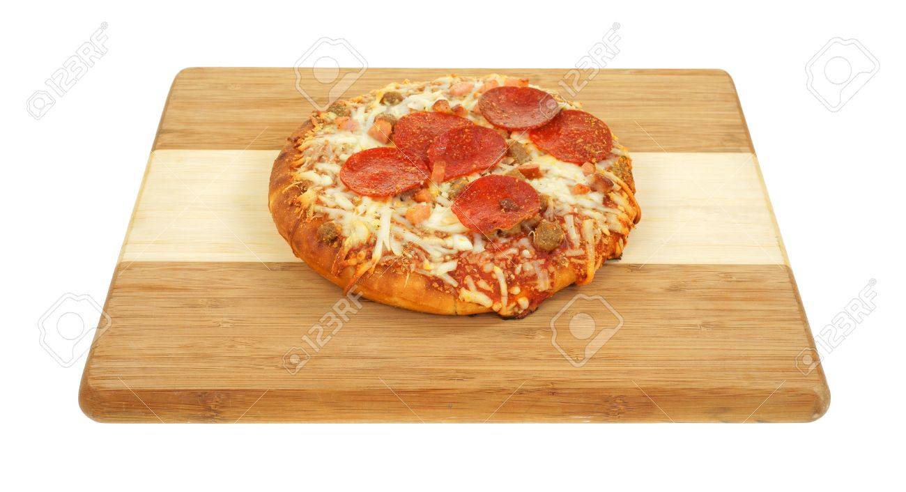 a freshly cooked personal size thick pan pizza on a wood cutting personal pan pizza size