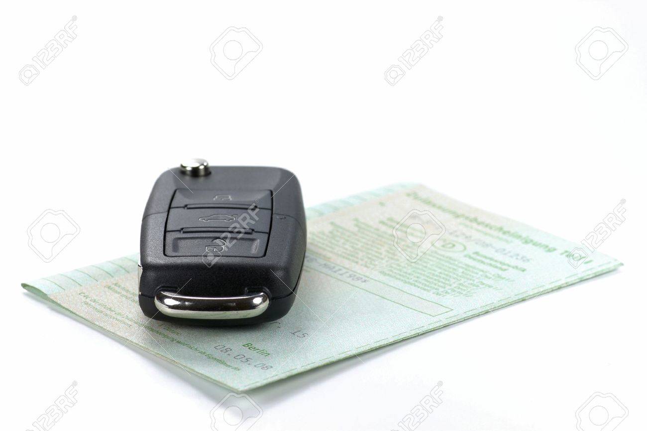 car key with German vehicle registration certificate isolated on white background - 54243539 car key with German vehicle registration certificate isolated on white background - 54243539