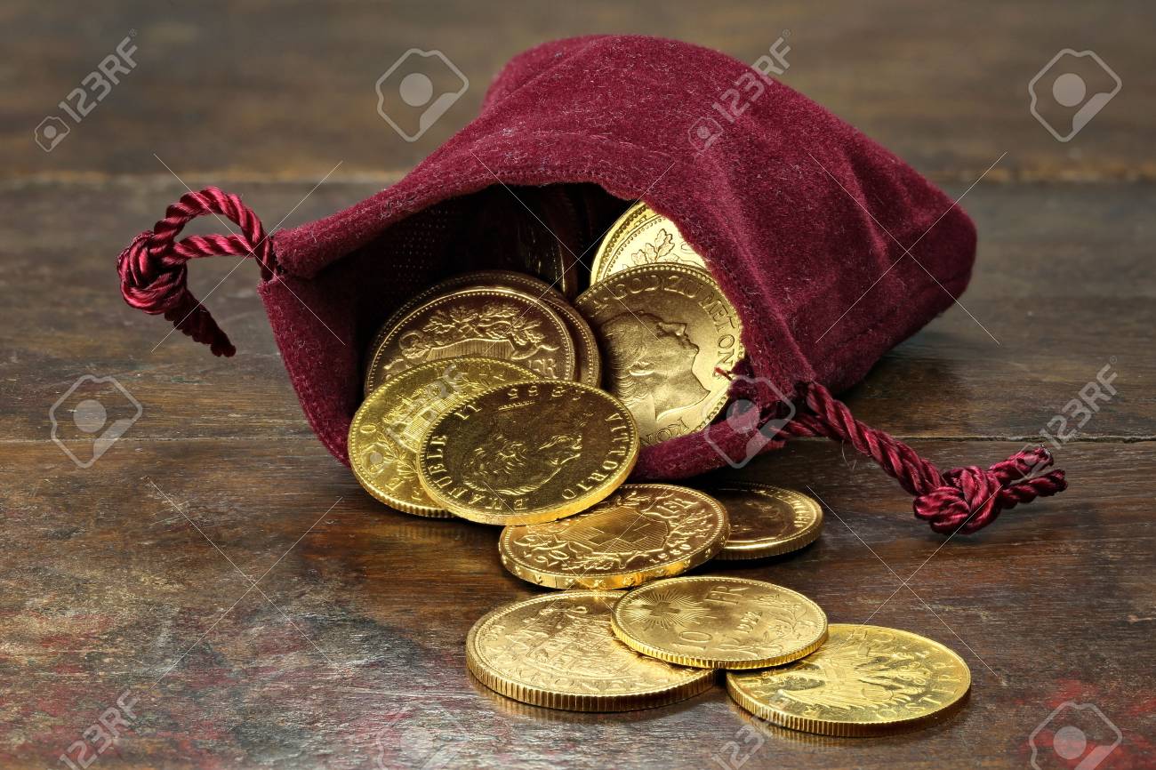 various European circulation gold coins from the 19th / 20th century in a velvet purse on rustic wooden background - 68965213 various European circulation gold coins from the 19th / 20th century in a velvet purse on rustic wooden background - 68965213