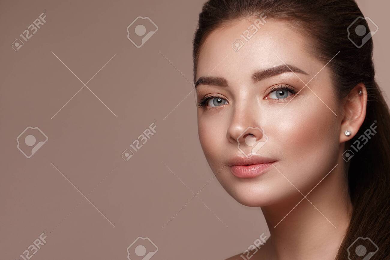 Beautiful Young Girl With Natural Nude Make-up With Cosmetic In Hands. Beauty  Face. Photo Taken In Studio Stock Photo, Picture and Royalty Free Image.  Image 146192274.