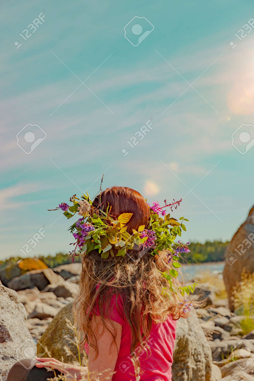 Brunette woman with wreath of flowers in Sweden - 169245000 Brunette woman with wreath of flowers in Sweden - 169245000