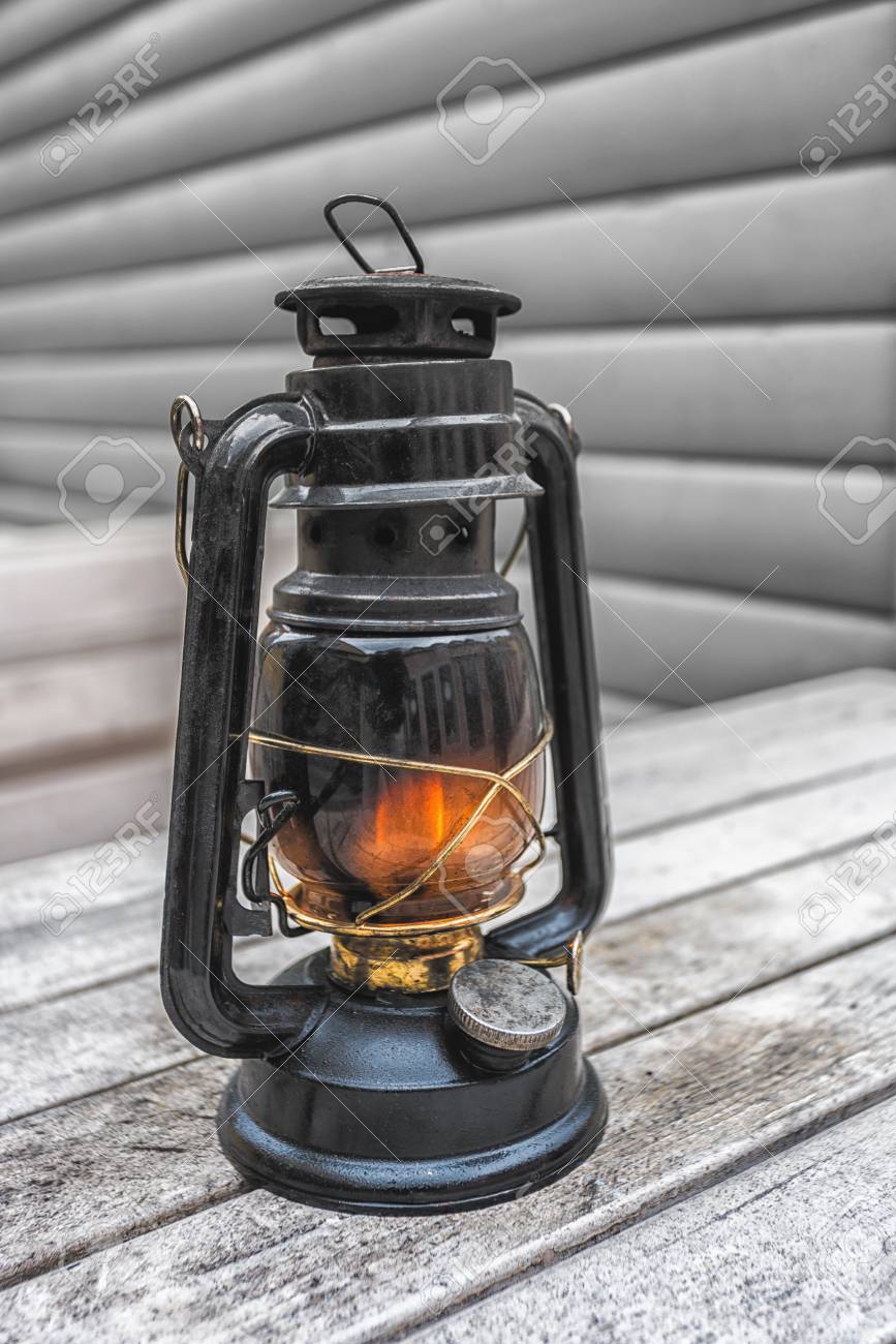 Old Fashioned Lantern On The Wooden Table. Vintage Style Metal