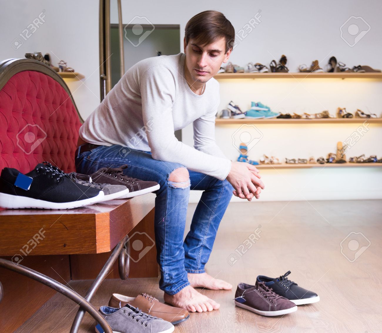 Barefoot Guy Chooses Winter Shoes At Fashion Shoe Store Stock Photo Picture And Royalty Free Image Image 53077061