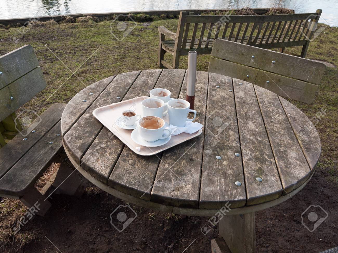 used white cups on tray on wooden table outside cafe essex stock