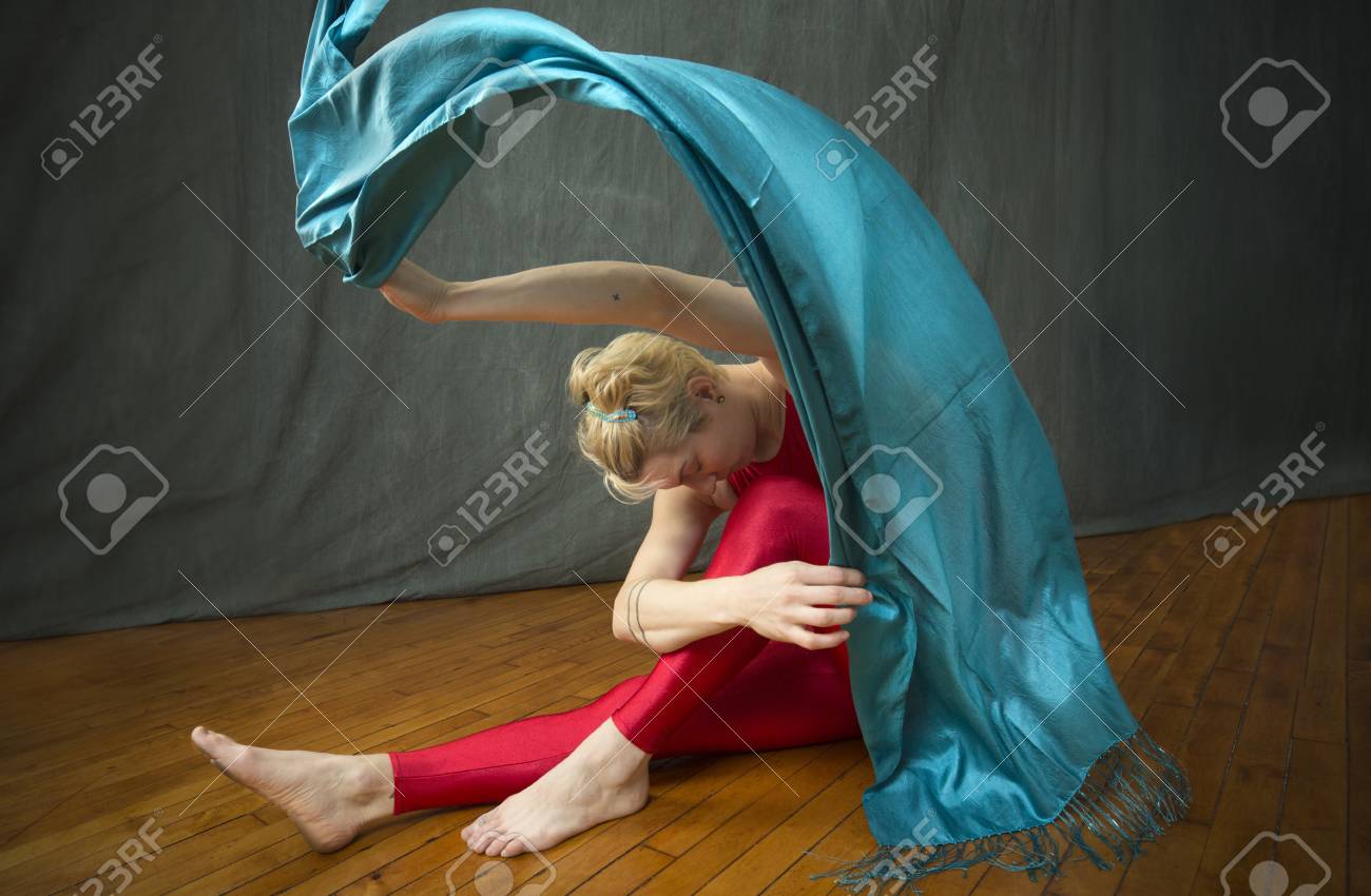 Active Young Woman Dancer With Short Blonde Hair In A Red Unitard