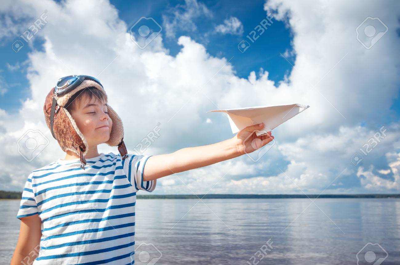 boy playing with a paper plane in aviator hat - 71054301 boy playing with a paper plane in aviator hat - 71054301