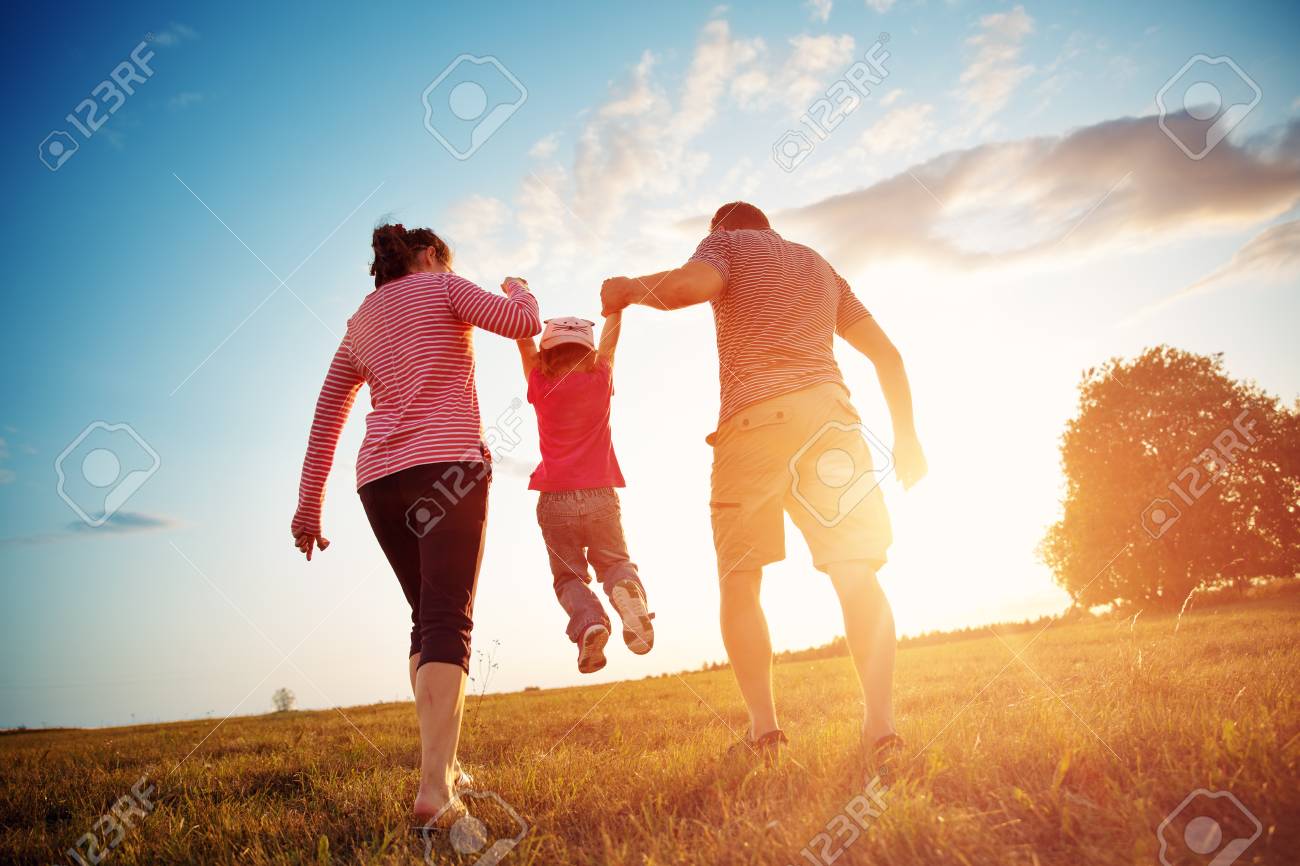 girl with mother and father holding hands on the nature - 106751799 girl with mother and father holding hands on the nature - 106751799