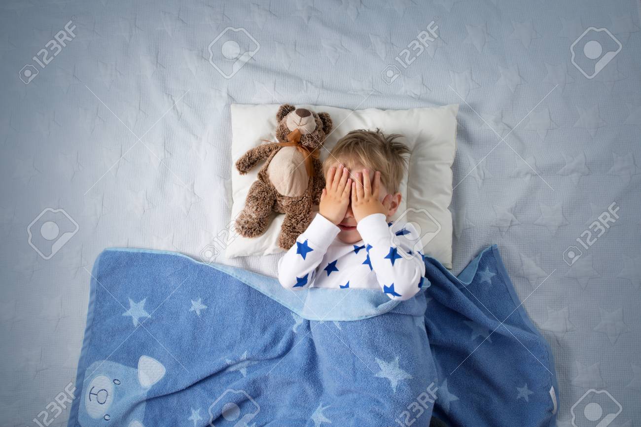 Three years old child crying in bed. Sad boy on pillow in bedroom - 107294144 Three years old child crying in bed. Sad boy on pillow in bedroom - 107294144