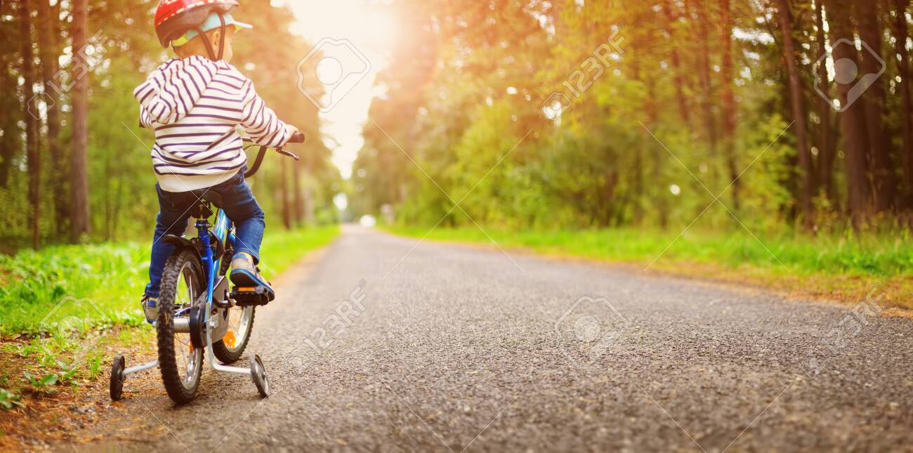a child on a bicycle in helmet - 131649348 a child on a bicycle in helmet - 131649348