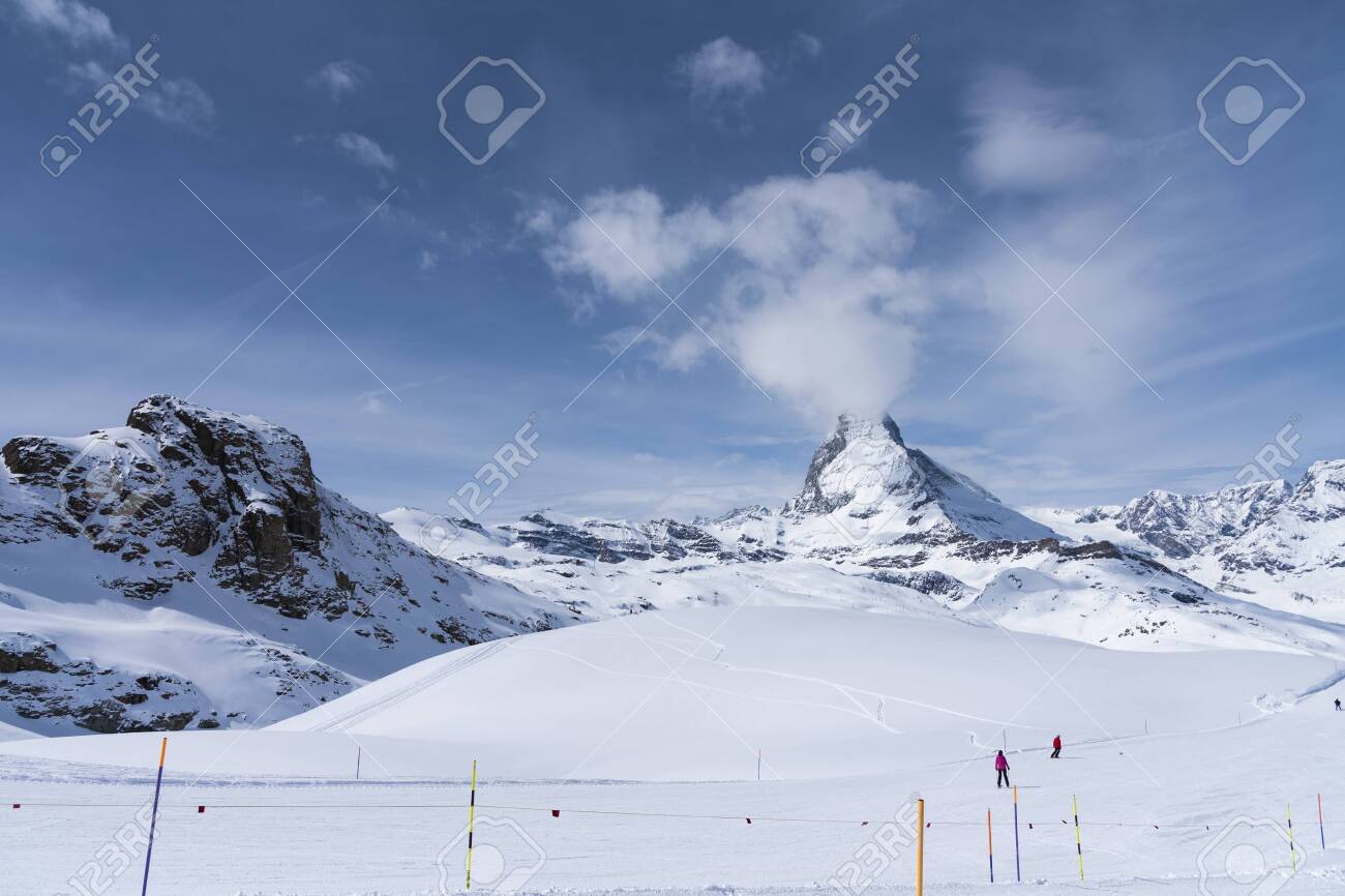 The famous mountain Matterhorn peak with cloudy and blue sky from Gornergrat, Zermatt, Switzerland - 131648560 The famous mountain Matterhorn peak with cloudy and blue sky from Gornergrat, Zermatt, Switzerland - 131648560