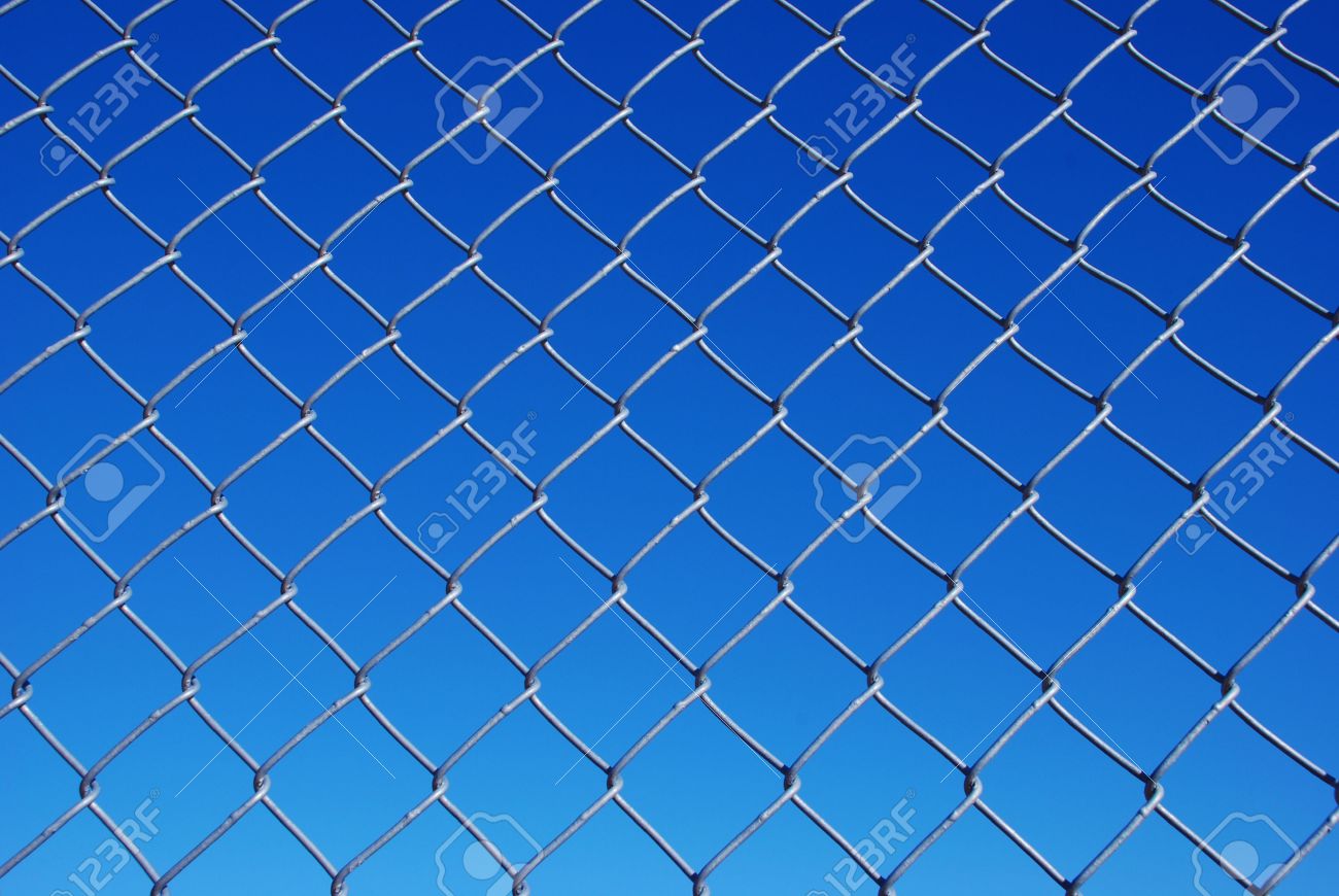 chain link fence with background sky from light to dark blue stock