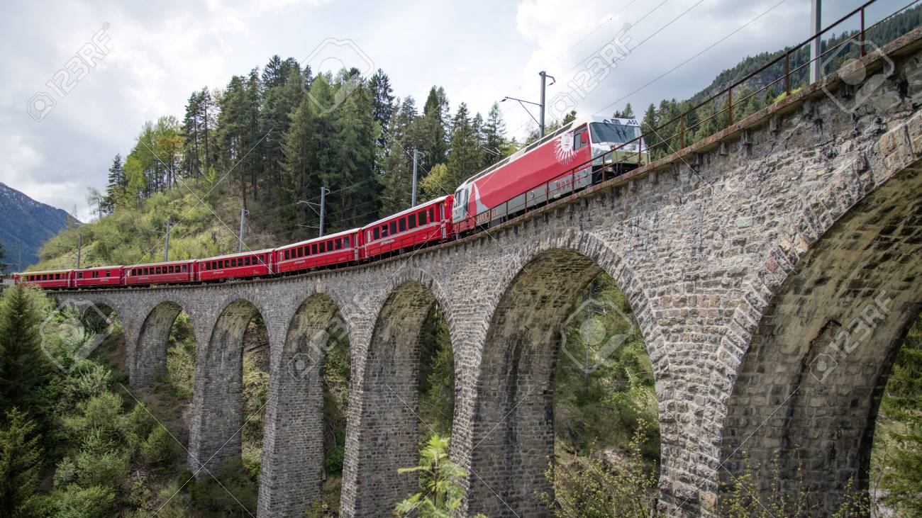 Albula - Switzerland - May 2017: Glacier train on famous landwasser Viaduct bridge.The Rhaetian Railway section from the Albula - Bernina area, Switzerland, Europe. - 93106503 Albula - Switzerland - May 2017: Glacier train on famous landwasser Viaduct bridge.The Rhaetian Railway section from the Albula - Bernina area, Switzerland, Europe. - 93106503