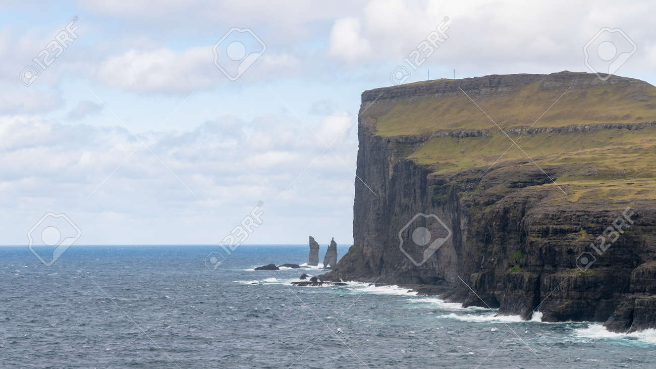 Risin and Kellingin rocks as seen from Tjornuvik bay with waves hitting the shore on Streymoy on the Faroe Islands, Denmark, Europe - 164385888 Risin and Kellingin rocks as seen from Tjornuvik bay with waves hitting the shore on Streymoy on the Faroe Islands, Denmark, Europe - 164385888