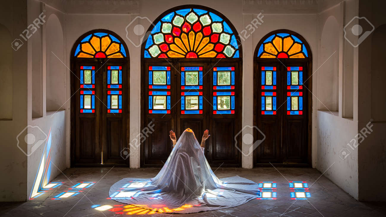 Kashan, Iran - May 2019: Unidentified Iranian woman in chador hijab praying inside Tabatabaei Natanzi Khaneh Historical House - 164356043 Kashan, Iran - May 2019: Unidentified Iranian woman in chador hijab praying inside Tabatabaei Natanzi Khaneh Historical House - 164356043