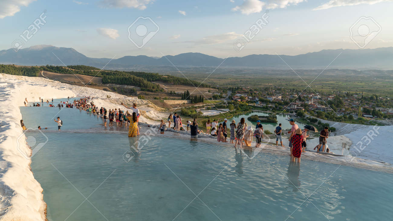 Pamukkale, Turkey - October 2019: Tourists on Pamukkale Travertine pools and terraces. Pamukkale is famous UNESCO world heritage site in Turkey - 164355965 Pamukkale, Turkey - October 2019: Tourists on Pamukkale Travertine pools and terraces. Pamukkale is famous UNESCO world heritage site in Turkey - 164355965