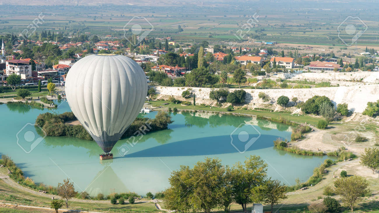 Denizli, Turkey - October 2019: Hot air balloon touching the pool near Pamukkale travertine - 164355963 Denizli, Turkey - October 2019: Hot air balloon touching the pool near Pamukkale travertine - 164355963