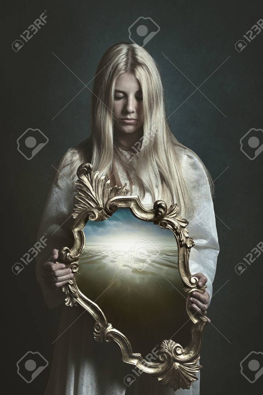 stock photo woman holding magical mirror imagination and surreal woman mirror t57 woman