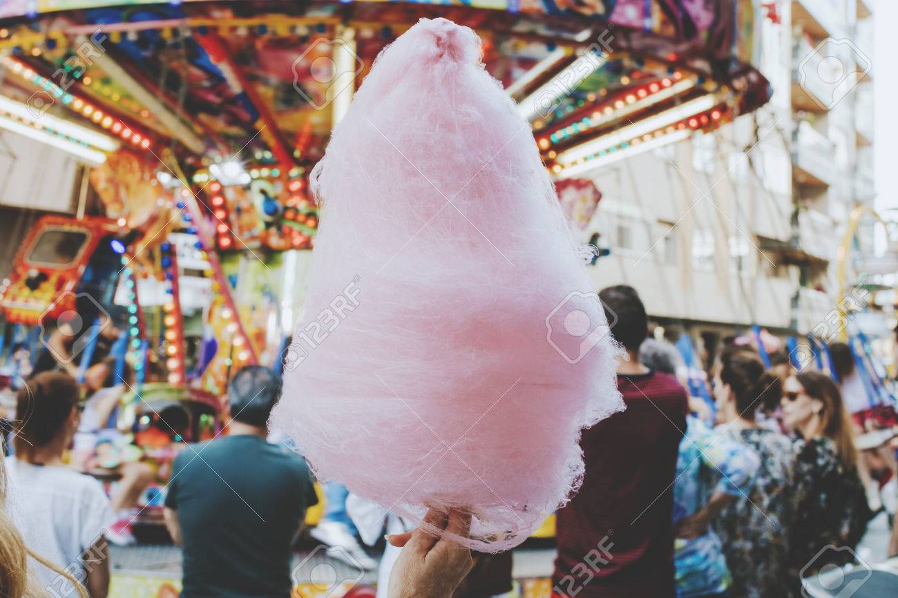 young woman with cotton candy at the party - 80504950 young woman with cotton candy at the party - 80504950
