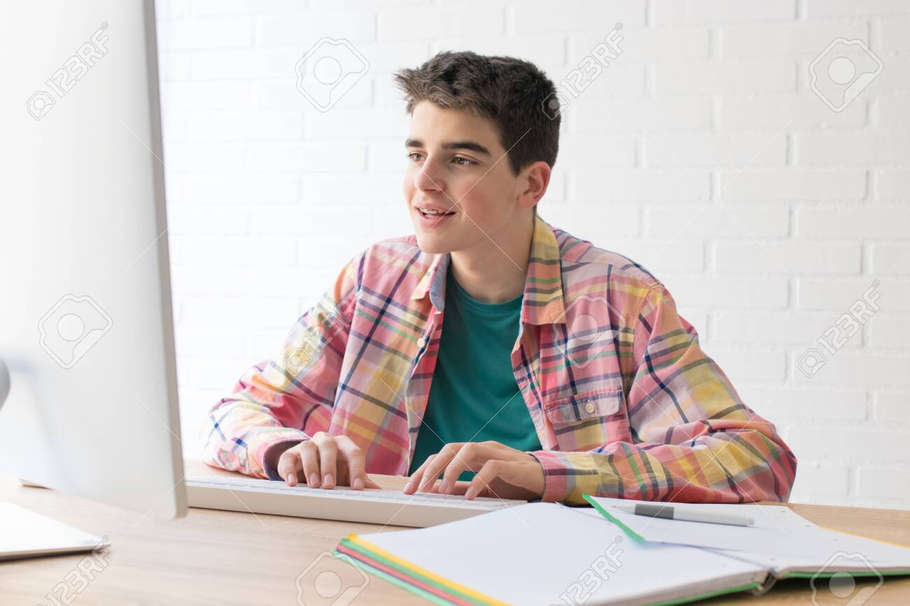 student or teenager with the computer on the desktop - 129876491 student or teenager with the computer on the desktop - 129876491