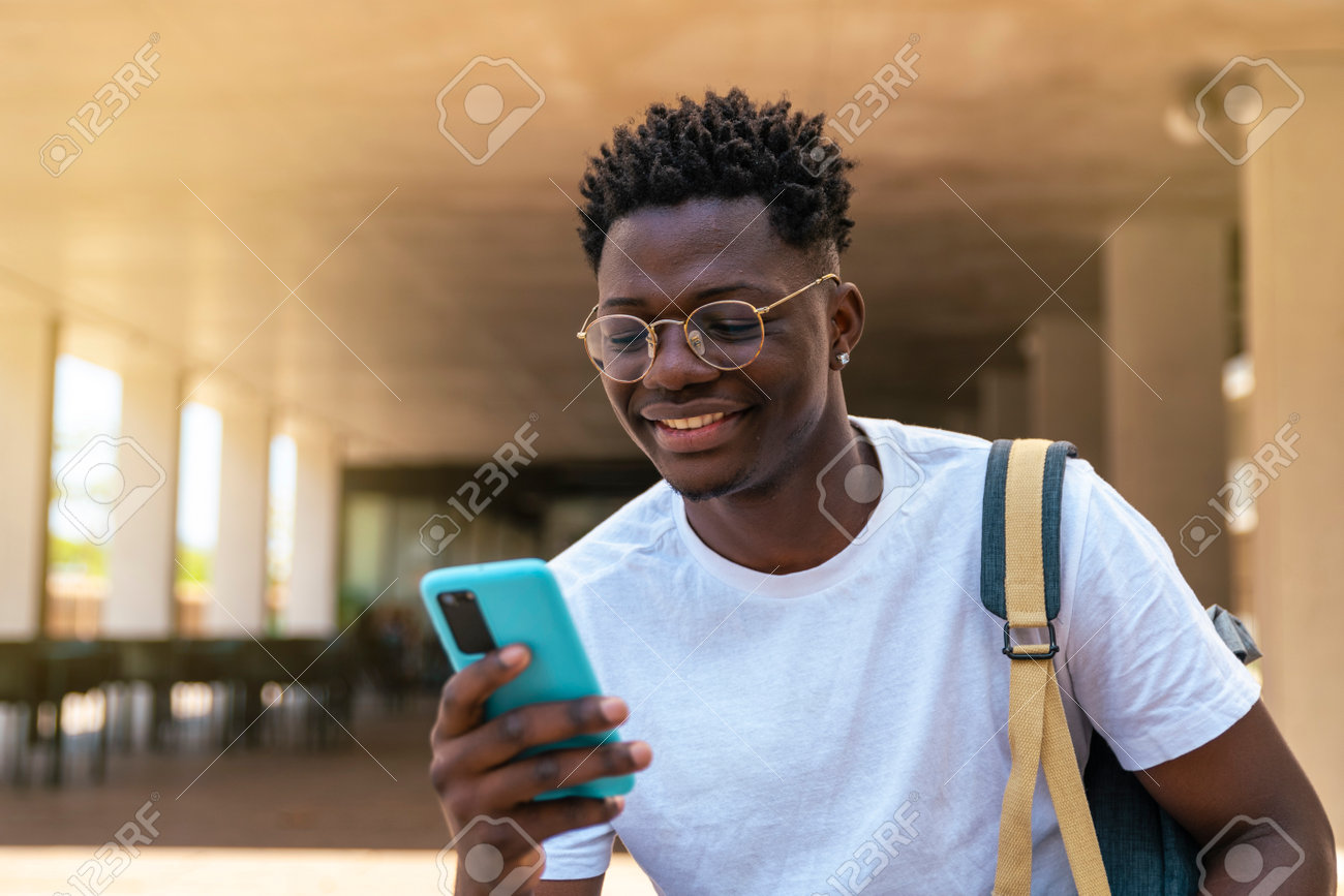 https://previews.123rf.com/images/carlesiturbe/carlesiturbe2302/carlesiturbe230200006/199657185-happy-young-student-sitting-and-using-his-mobile-phone-in-the-university-education-concept.jpg