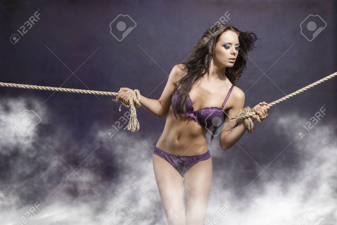 Hot Portrait Of Very Sexy Brunette Girl With Long Flying Hair Tied By Rope.  She Wearing Purple Underwear Stock Photo, Picture and Royalty Free Image.  Image 24426073.