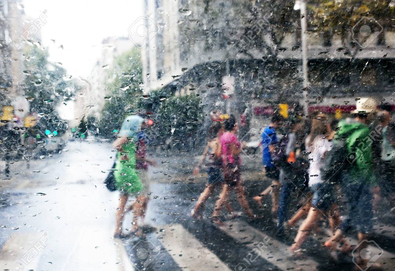 Abstract Image Of People Walking In The Rain In The City Stock