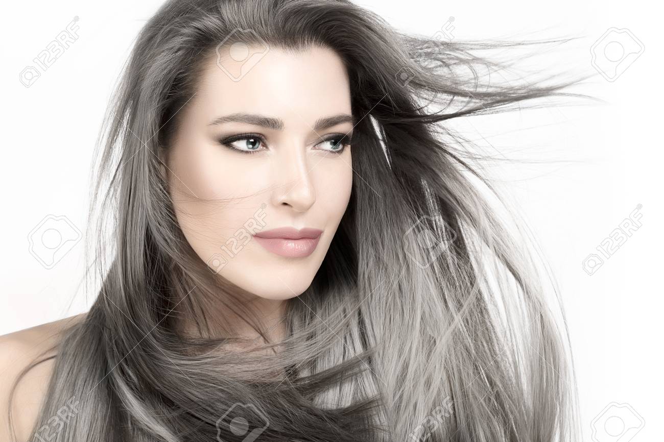 Attractive young woman with long trendy silver hair blowing in a breeze. - 118905056 Attractive young woman with long trendy silver hair blowing in a breeze. - 118905056
