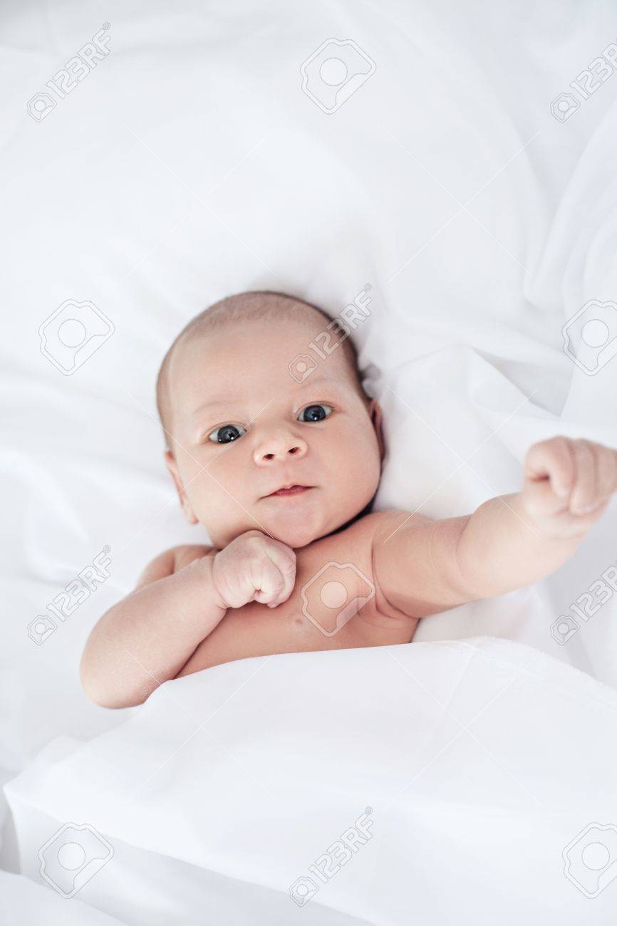 Cute And Funny Newborn Baby Boy Awake In The Bed Stock Photo