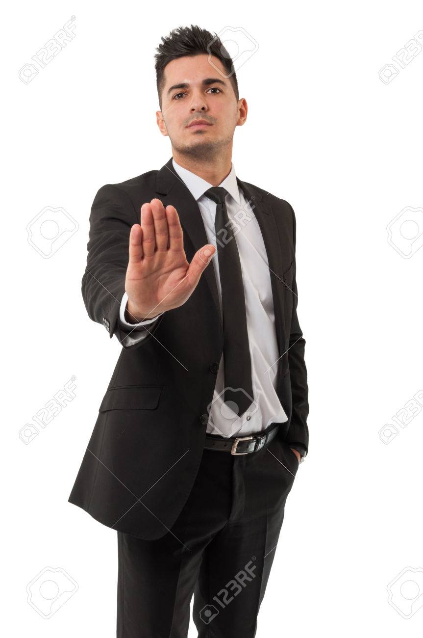 Business man wearing a classic black suit is saying stay right there by using his right hand - 26582850 Business man wearing a classic black suit is saying stay right there by using his right hand - 26582850