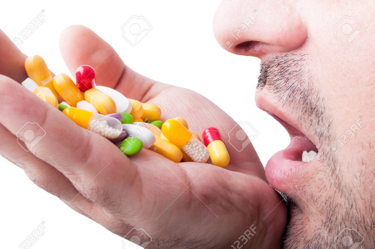 35478110-man-taking-a-lof-of-pills-for-his-depression.jpg