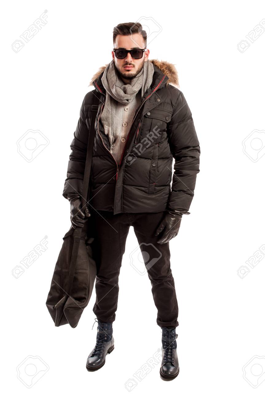 fashionable male model wearing winter clothes and a big bag on