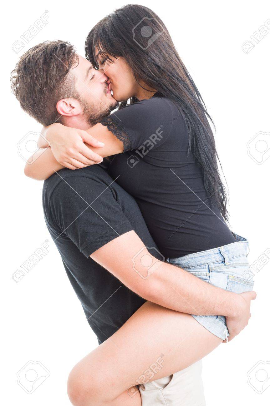 handsome boyfriend holding and kissing happy girlfriend on white