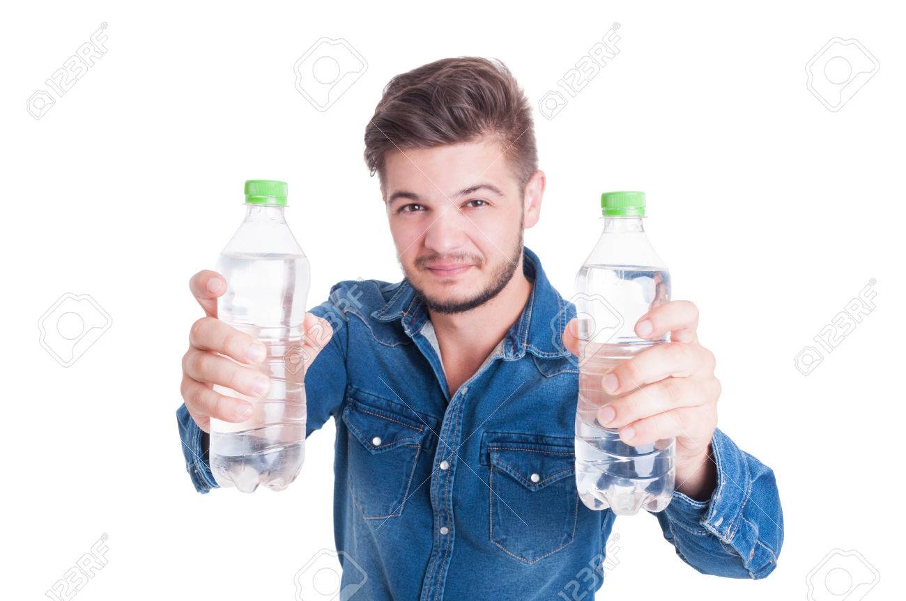 Handsome male model holding two bottles of cold water in summer heat season as dehydration concept - 43237519 Handsome male model holding two bottles of cold water in summer heat season as dehydration concept - 43237519