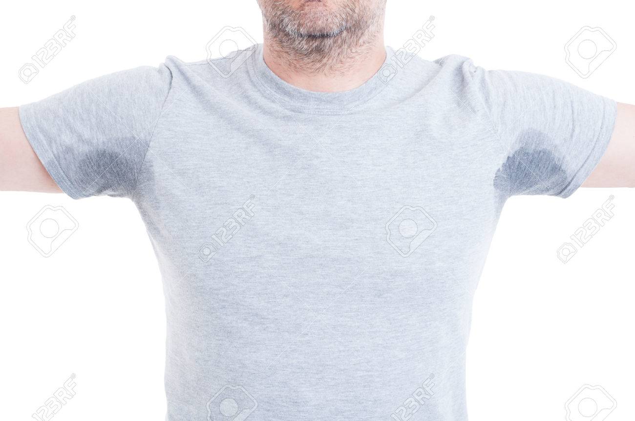 Man with both arms raised and excessive sweat stains on grey t-shirt isolated on white as hyperhidrosis concept - 57658413 Man with both arms raised and excessive sweat stains on grey t-shirt isolated on white as hyperhidrosis concept - 57658413