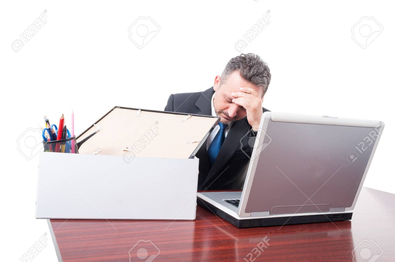 man at office with his personal stuff box being upset as being