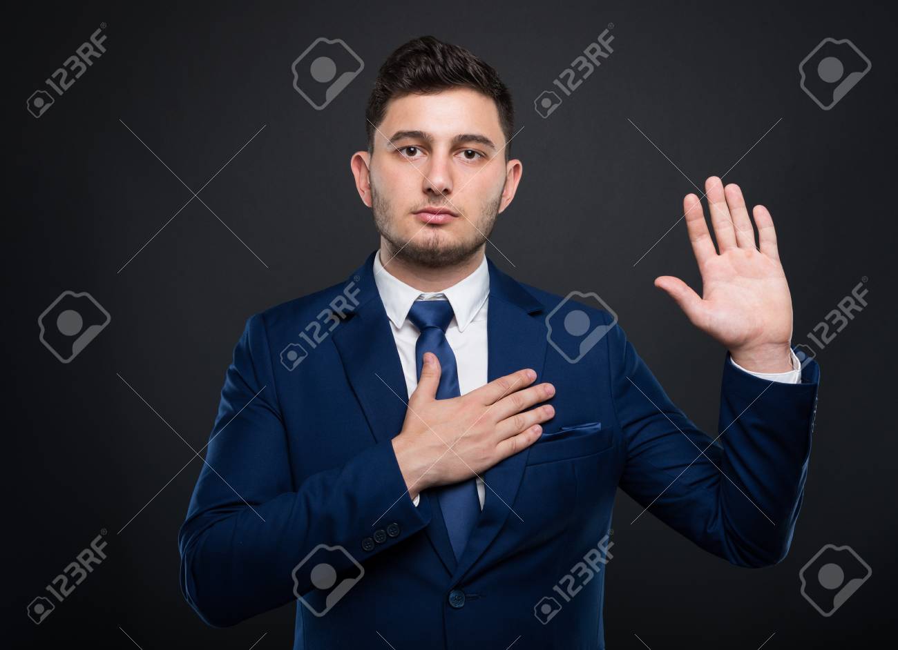 Businessman holds his hand on his chest and taking a solemn vow - 89590163 Businessman holds his hand on his chest and taking a solemn vow - 89590163
