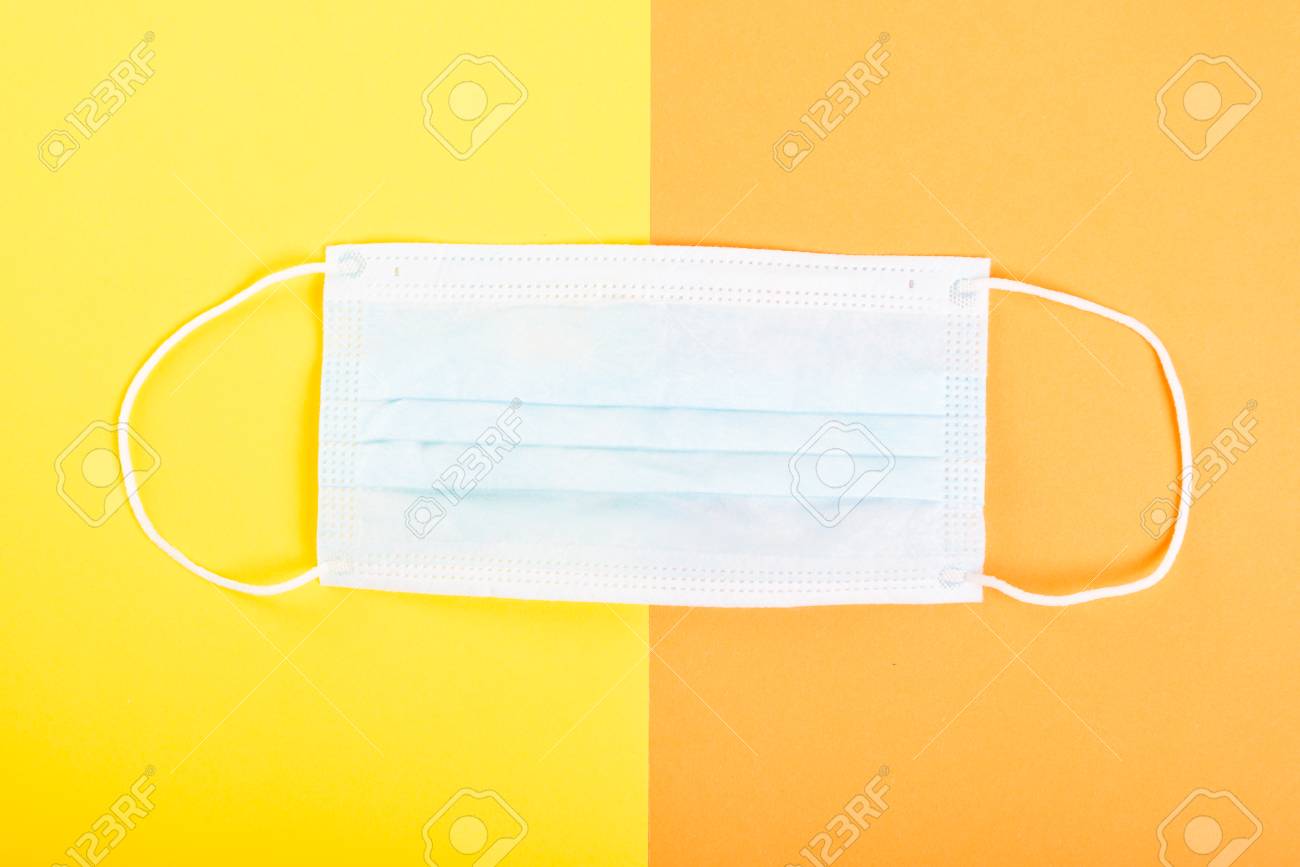 Download One Face Sterile Mask On Yellow And Orange Background Stock Photo Picture And Royalty Free Image Image 97944472 PSD Mockup Templates