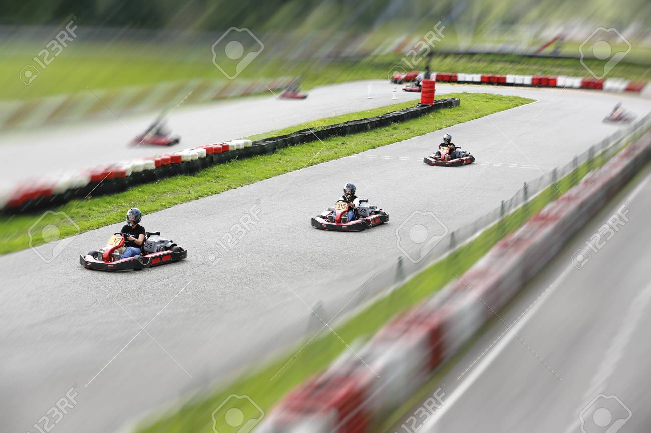 Go Kart Pilot Is Racing A Race In An Outdoor Go Karting Circuit