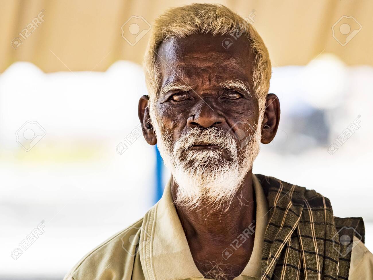PUDUCHERY, INDIA - DECEMBER Circa, 2018. An Unidentifed Old Senior Indian Poor Man Portrait With A Dark Brown Wrinkled Face And White Hair And A White Beard, Looks Serious. Emotional Picture Stock PUDUCHERY, INDIA - DECEMBER Circa, 2018. An Unidentifed Old Senior Indian Poor Man Portrait With A Dark Brown Wrinkled Face And White Hair And A White Beard, Looks Serious. Emotional Picture Stock