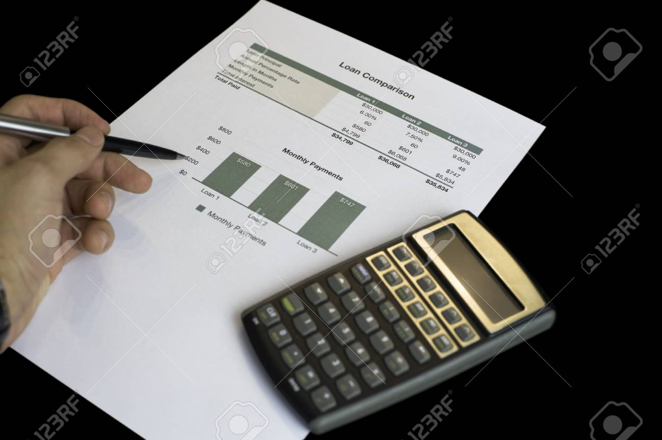 loan comparison data sheets calculator and pen stock photo loan comparison calculator