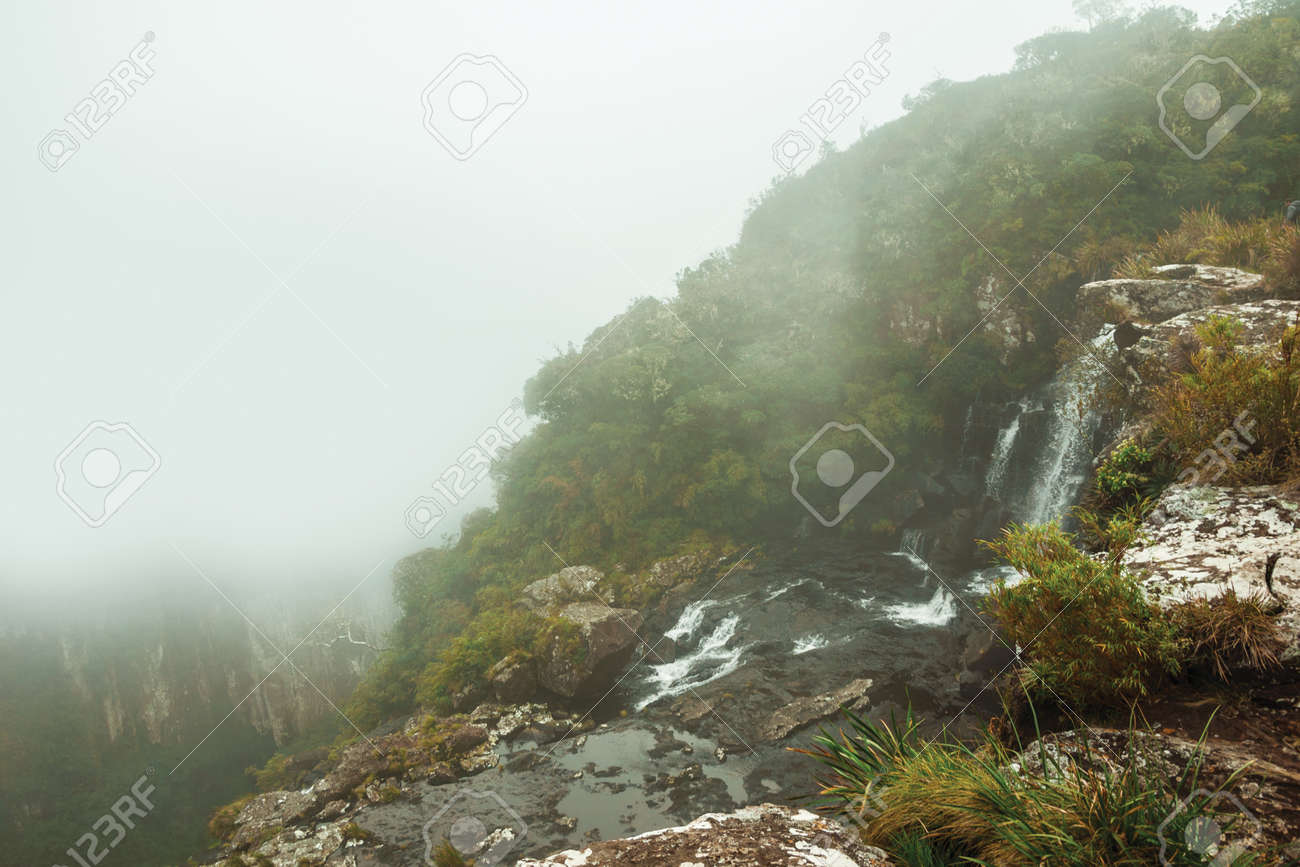 Black Tiger waterfall on cliff from a deep valley with mist at Serra Geral National Park near Cambara do Sul. A small country town in southern Brazil with amazing natural tourist attractions. - 136127270 Black Tiger waterfall on cliff from a deep valley with mist at Serra Geral National Park near Cambara do Sul. A small country town in southern Brazil with amazing natural tourist attractions. - 136127270