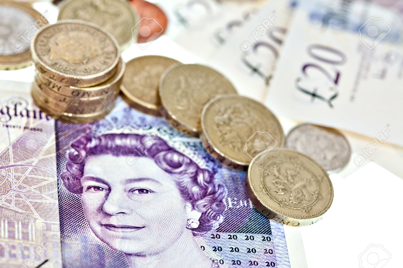 british pound sterling in coins and bank notes macro isolated