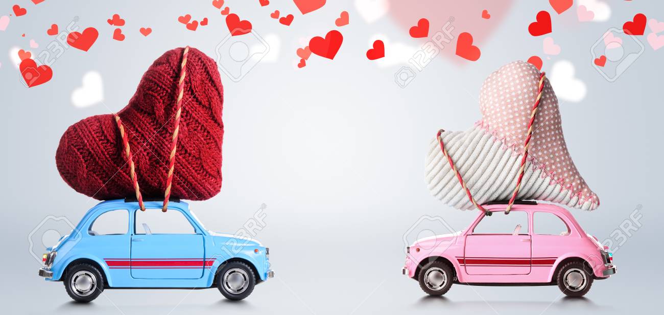 couple of retro toy cars delivering craft hearts for valentines valentines day cars