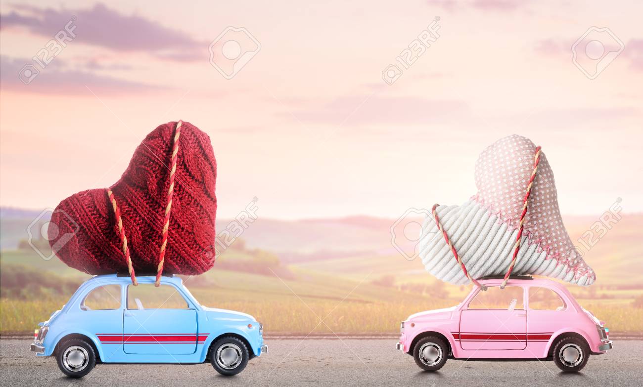 couple of retro toy cars delivering craft hearts for valentines valentines day cars