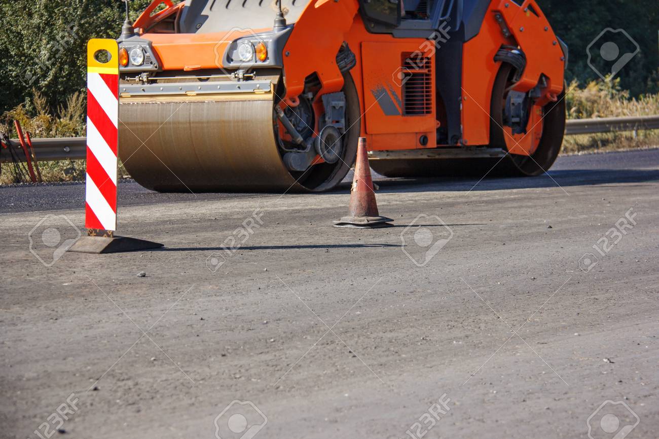 Carrying out repair works: asphalt roller stacking and pressing hot lay of asphalt. Machine repairing road. - 118032723 Carrying out repair works: asphalt roller stacking and pressing hot lay of asphalt. Machine repairing road. - 118032723